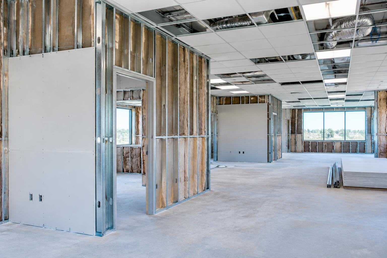 Commercial interior with metal studs, drywall, insulation and acoustical ceiling grid